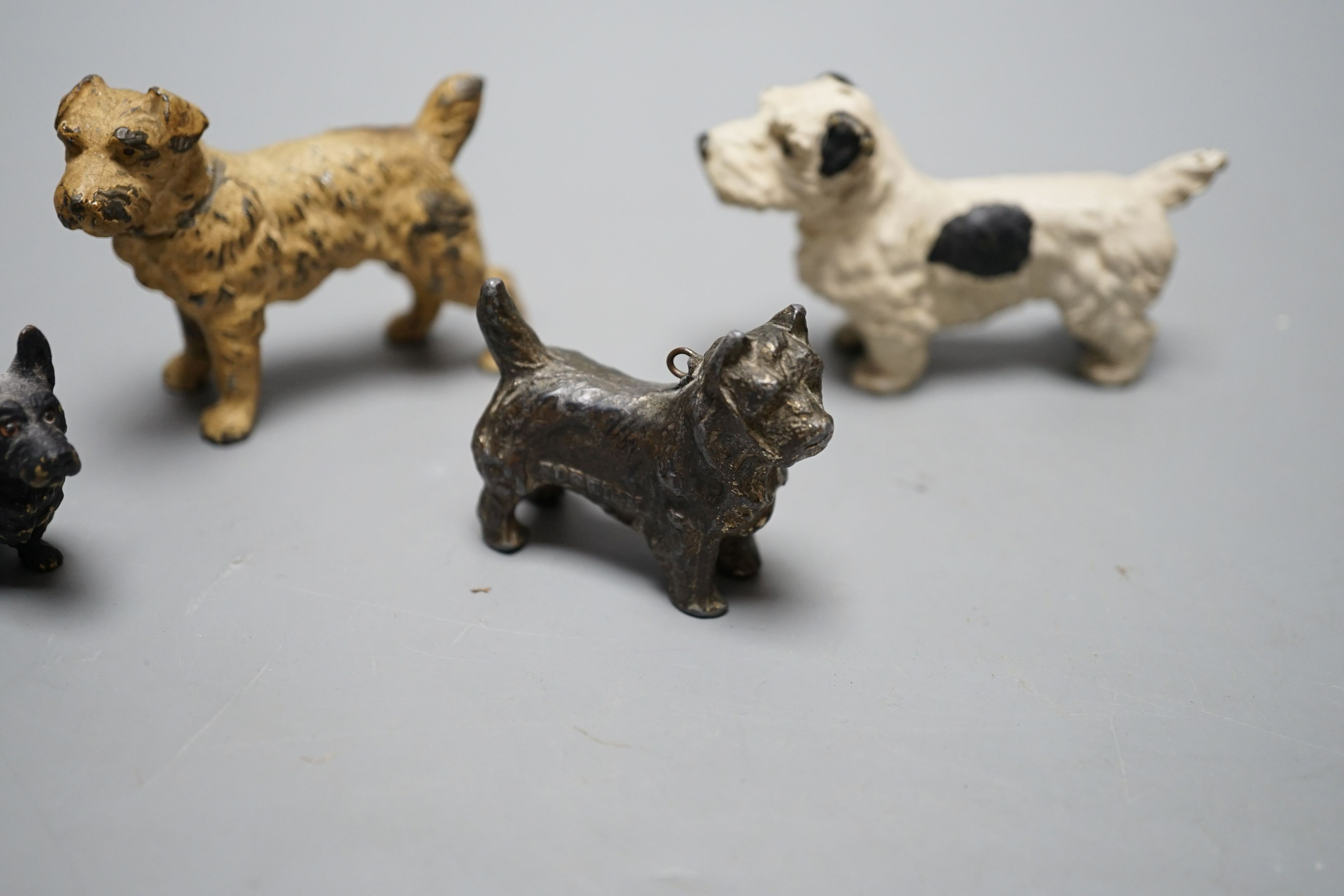 Four cold painted dogs, two bronze, tallest 5.5cm